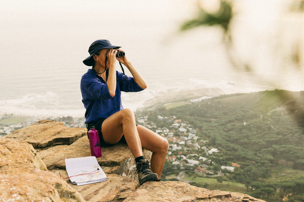 hiker looking through binoculars