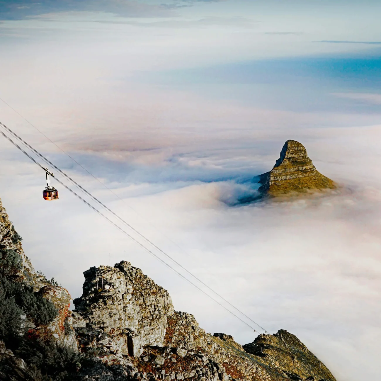Cable Car descending down mountain with mist below
