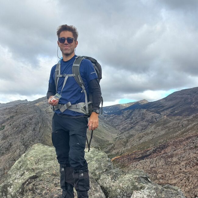 male hiker standing on mountain