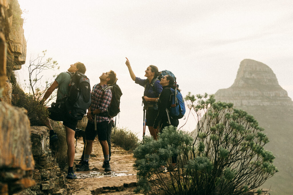 hiking guide pointing out a rock to other hikers on table mountain