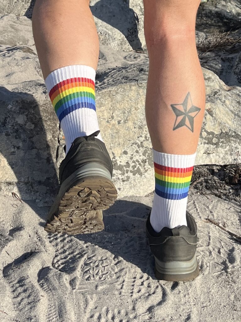 close-up of hiker's shoes with pride socks