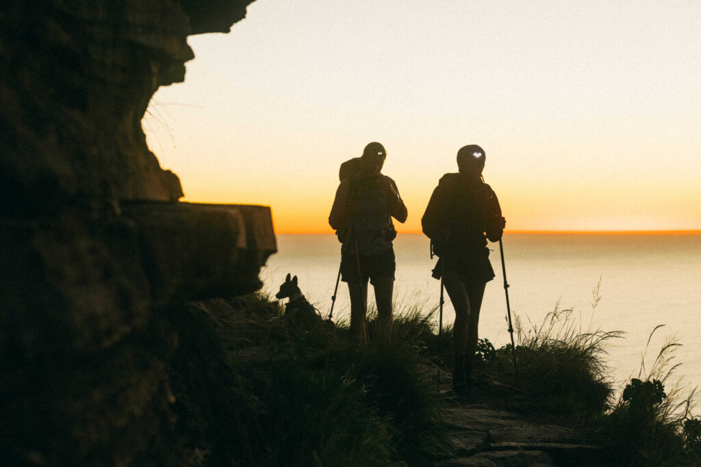 two hikers at sunrise on table mountain